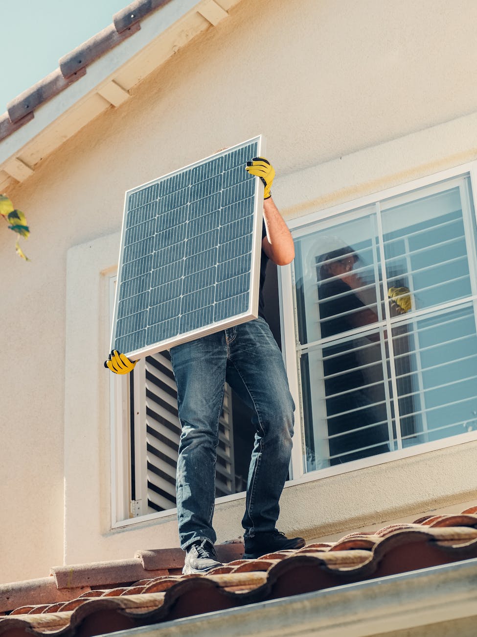 a man carrying solar panel